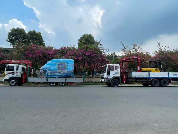 2 xe nâng cẩu đang chở hàng