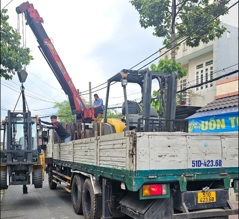 Xe cẩu đang bốc xe nâng ở Sài Gòn đi tỉnh